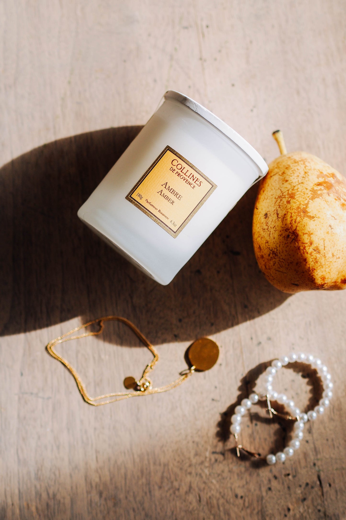 Amber Scented Candle, on a wooden surface