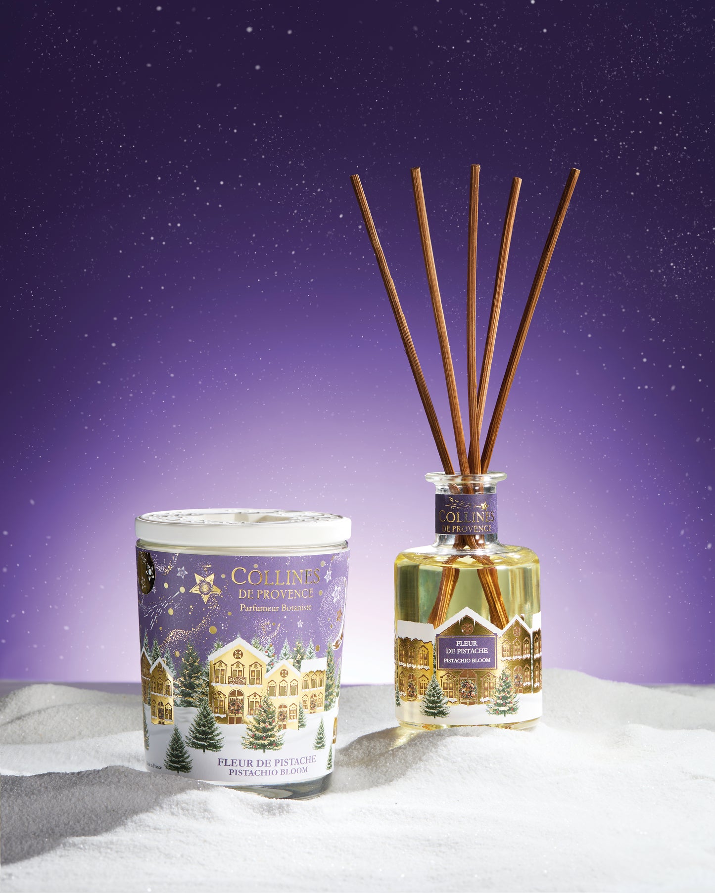 Collines de Provence pistachio bloom reed diffuser and scented candle on a snowy landscape with a starry night sky.