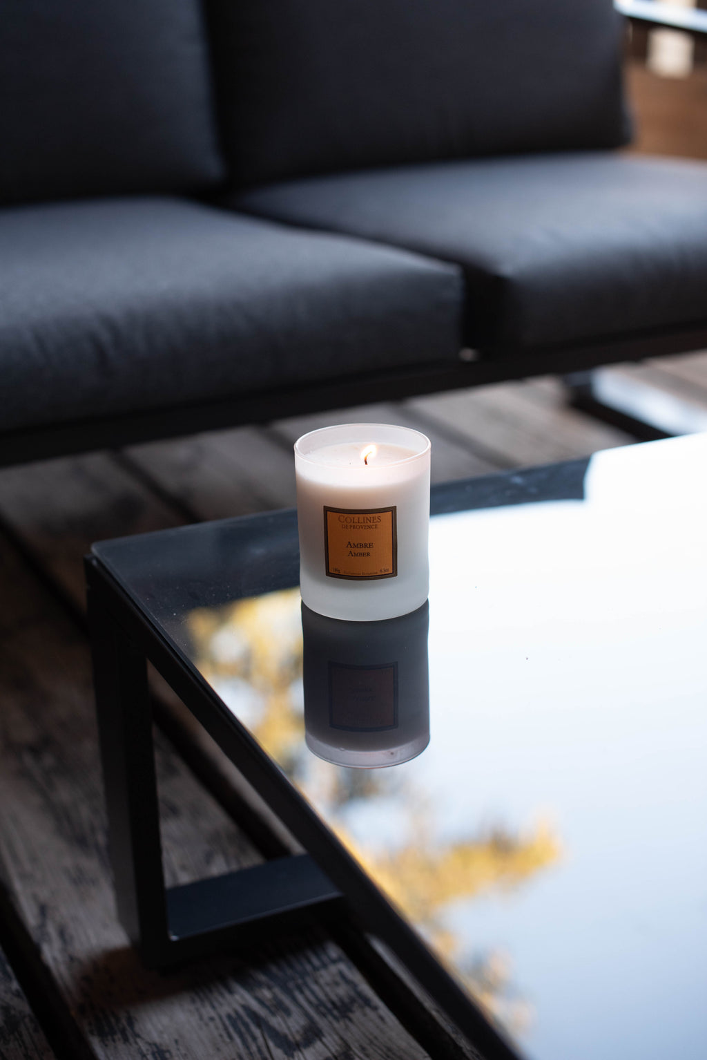 Amber Scented Candle, on a glass table