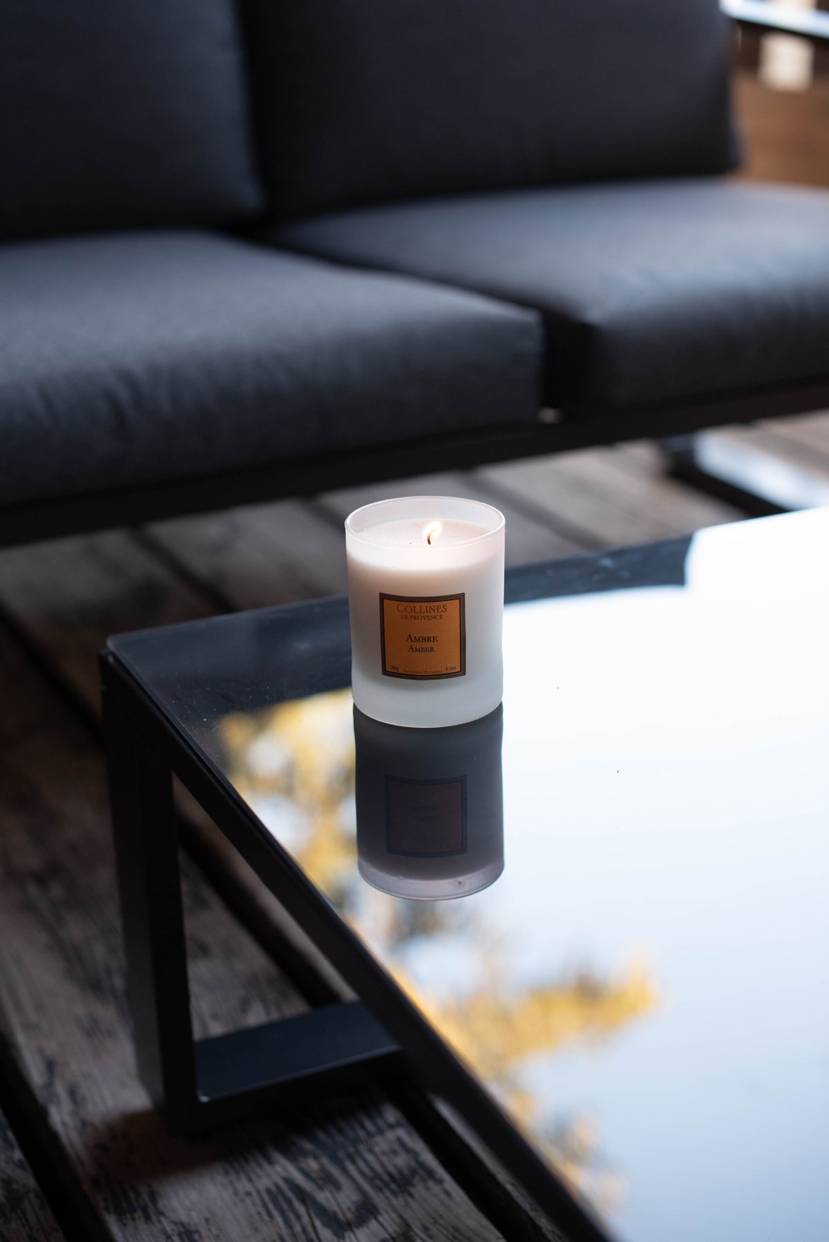 Amber Scented Candle, on a glass table