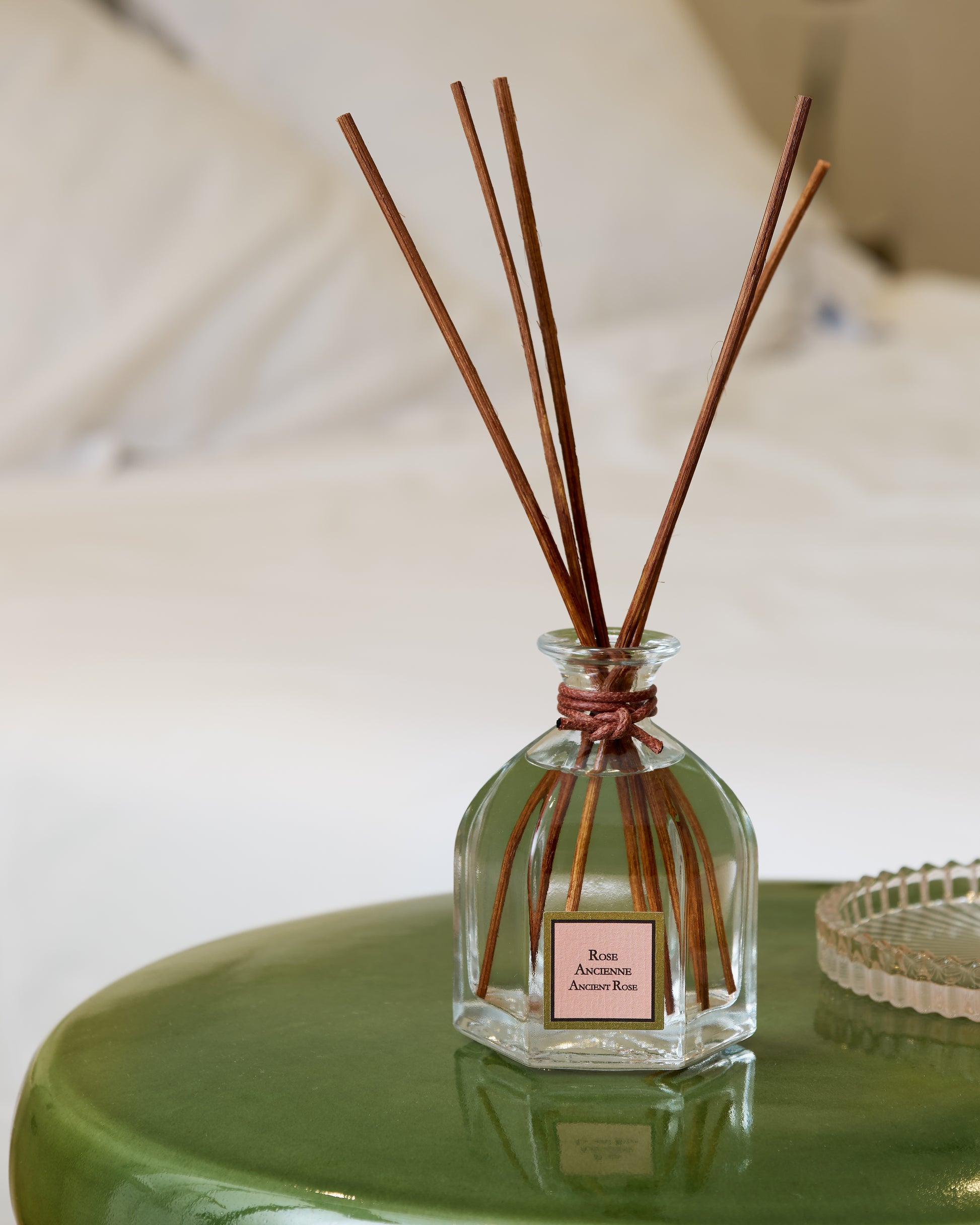 Collines de provence Ancient rose reed diffuser bottle, on a green surface