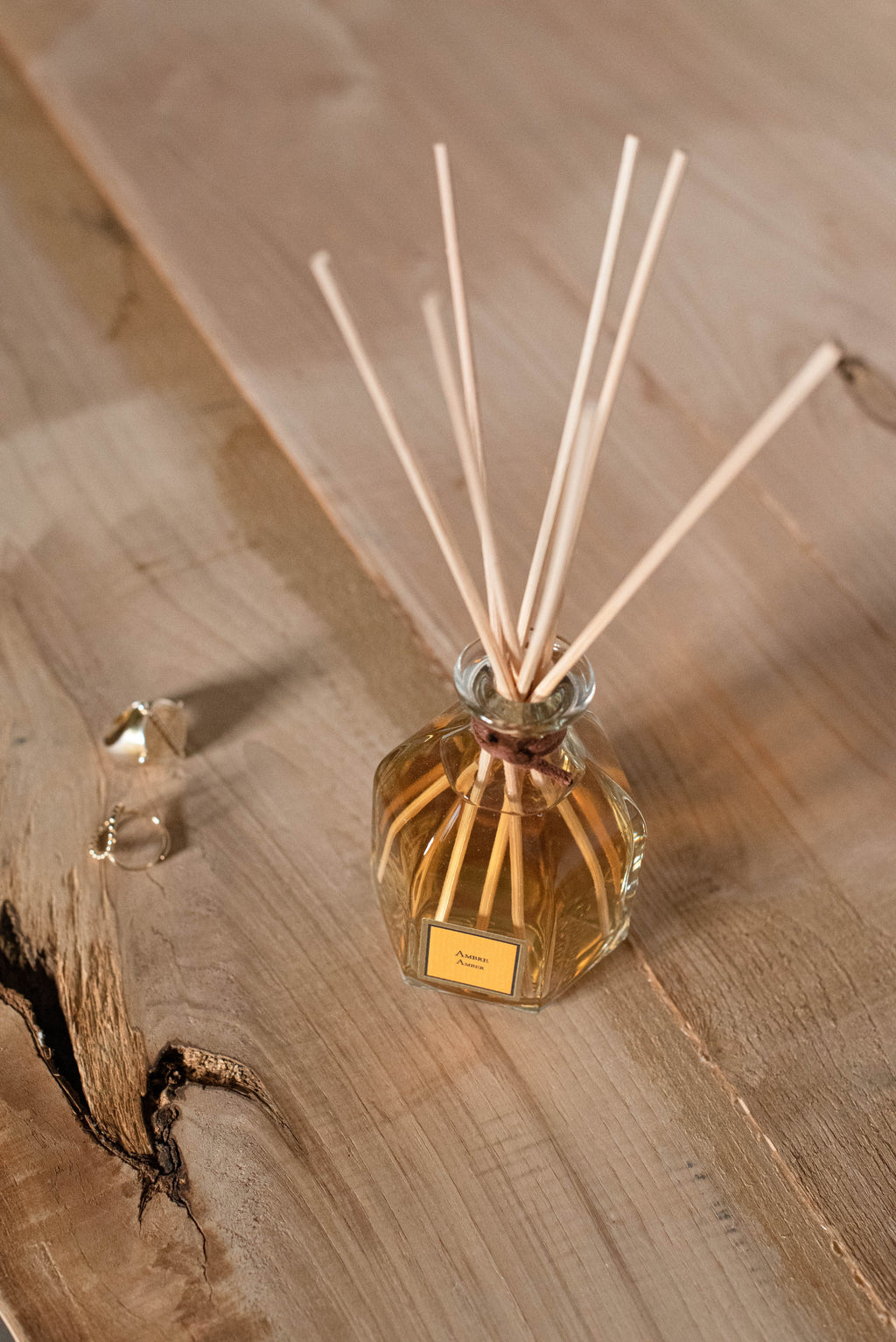 Amber Reed Diffuser, on a wooden surface