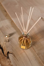 Amber Reed Diffuser, on a wooden surface