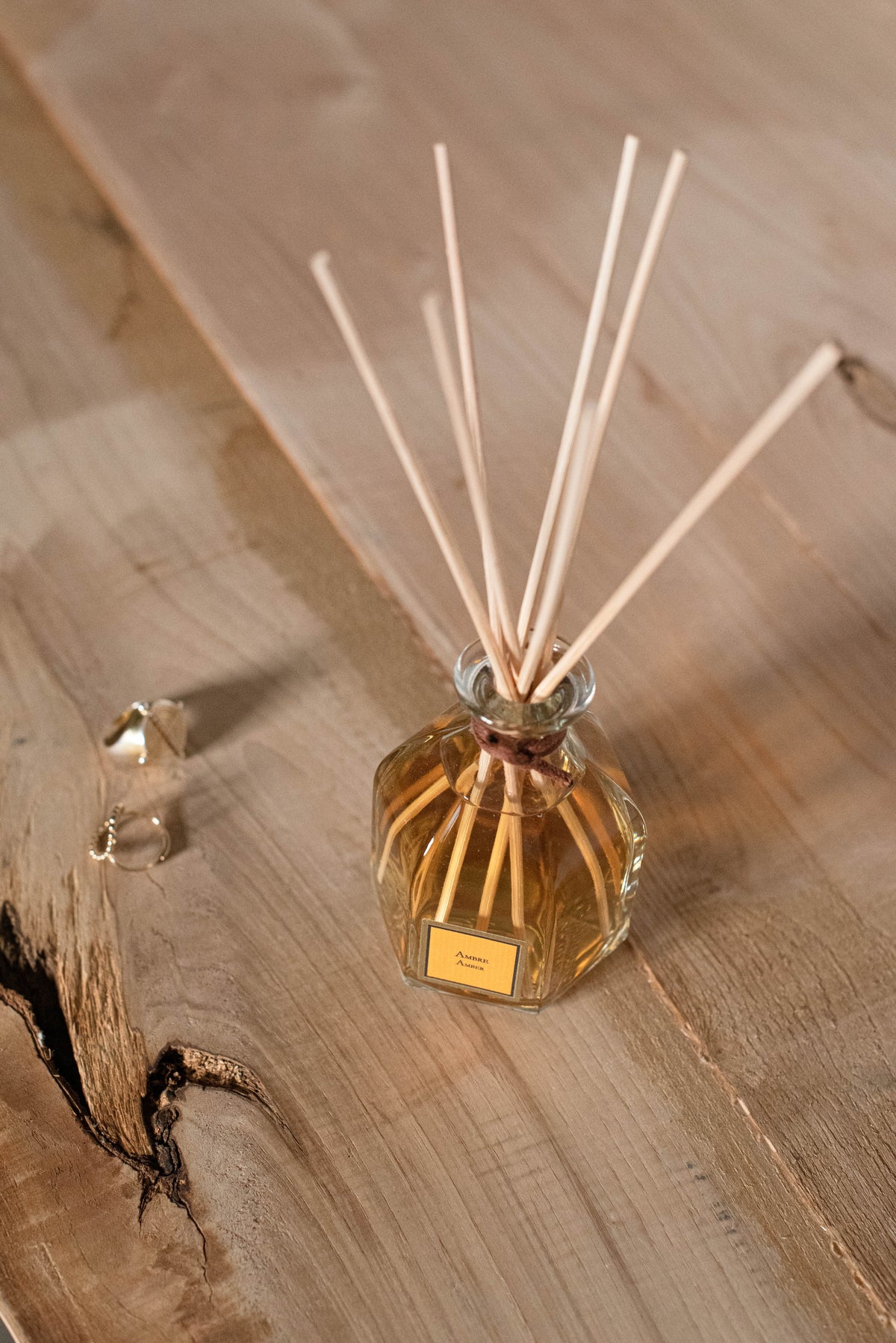 Amber Reed Diffuser, on a wooden surface
