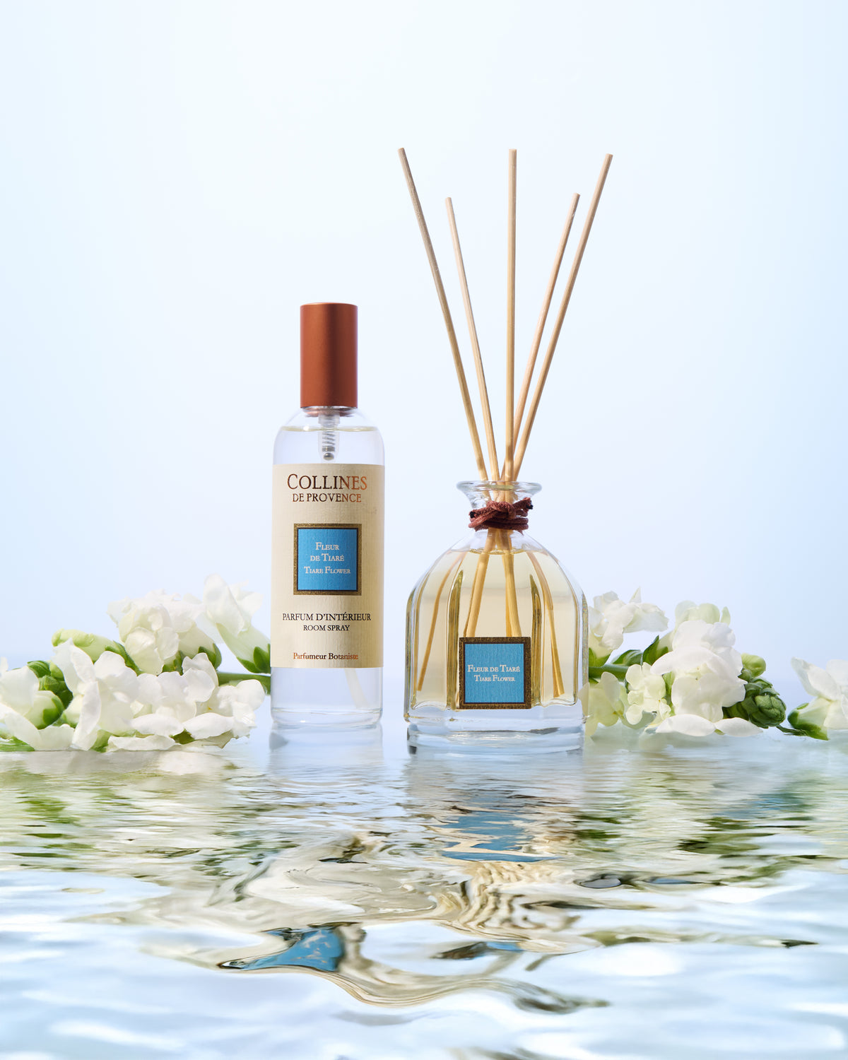 Collines de Provence tiare flower room spray bottle and reed diffuser on water with flowers