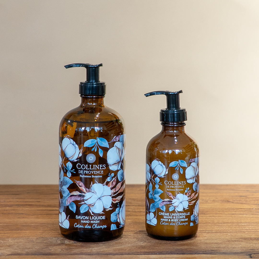 Cotton breeze bundle by Collines De Provence, composed of a bottle of cotton breeze liquid soap and a bottle of cotton breeze body lotion, front view, on a wooden surface
