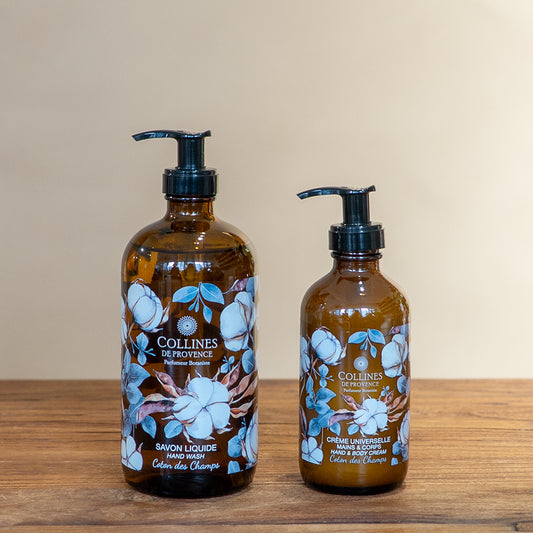 Cotton breeze bundle by Collines De Provence, composed of a bottle of cotton breeze liquid soap and a bottle of cotton breeze body lotion, front view, on a wooden surface