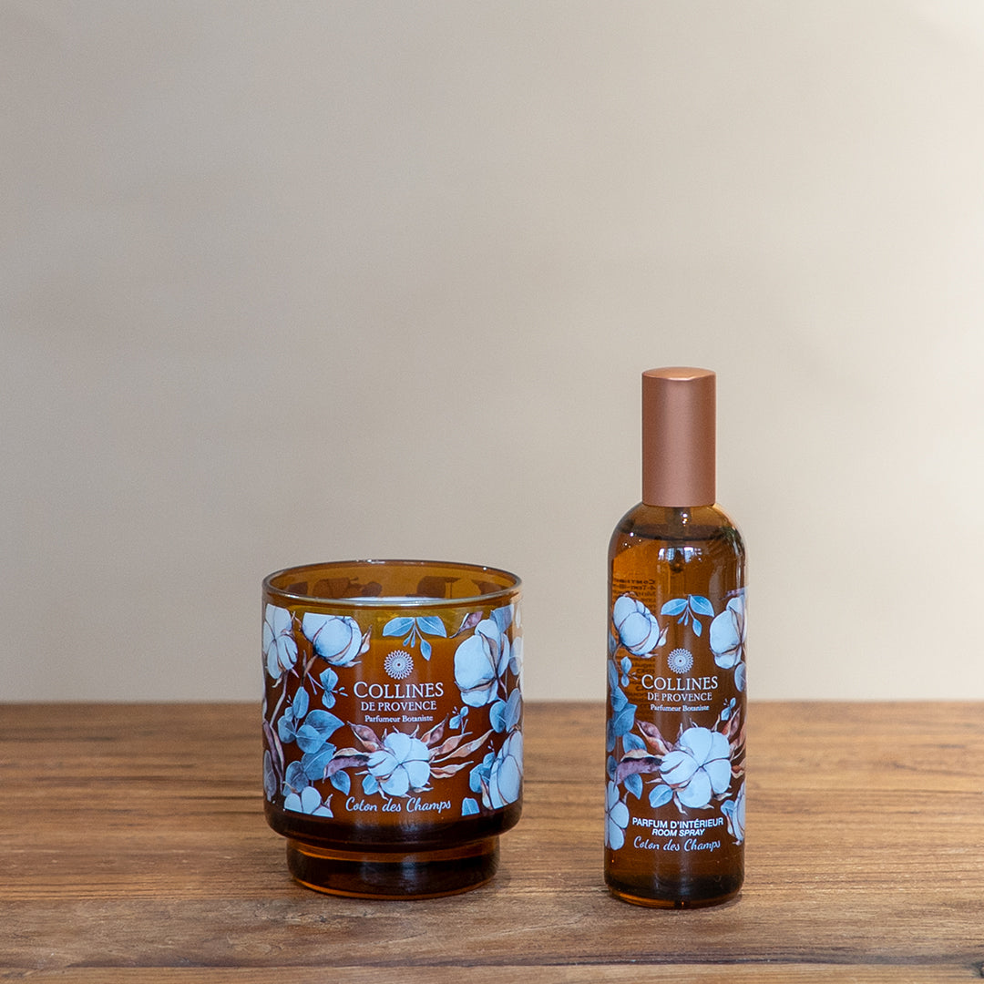 Collines de Provence Scented candle and room spray on a wooden surface with a beige background