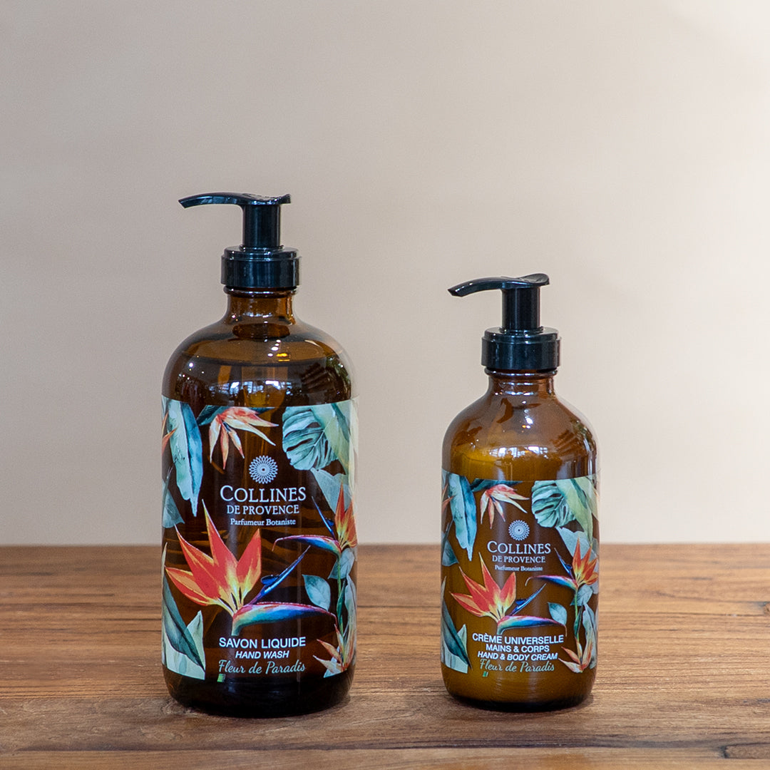 Paradise flower bundle by Collines De Provence, composed of a bottle of Paradise flower liquid soap and a bottle of Paradise flower body lotion, front view, on a wooden surface