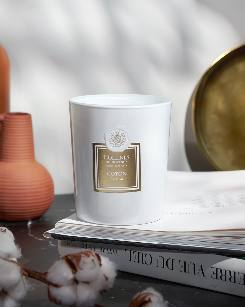 Cotton Scented Candle, on a book
