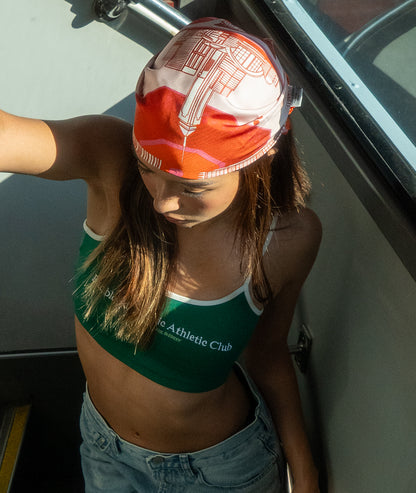 Person wearing a green athletic top and colorful botani bloom scarf