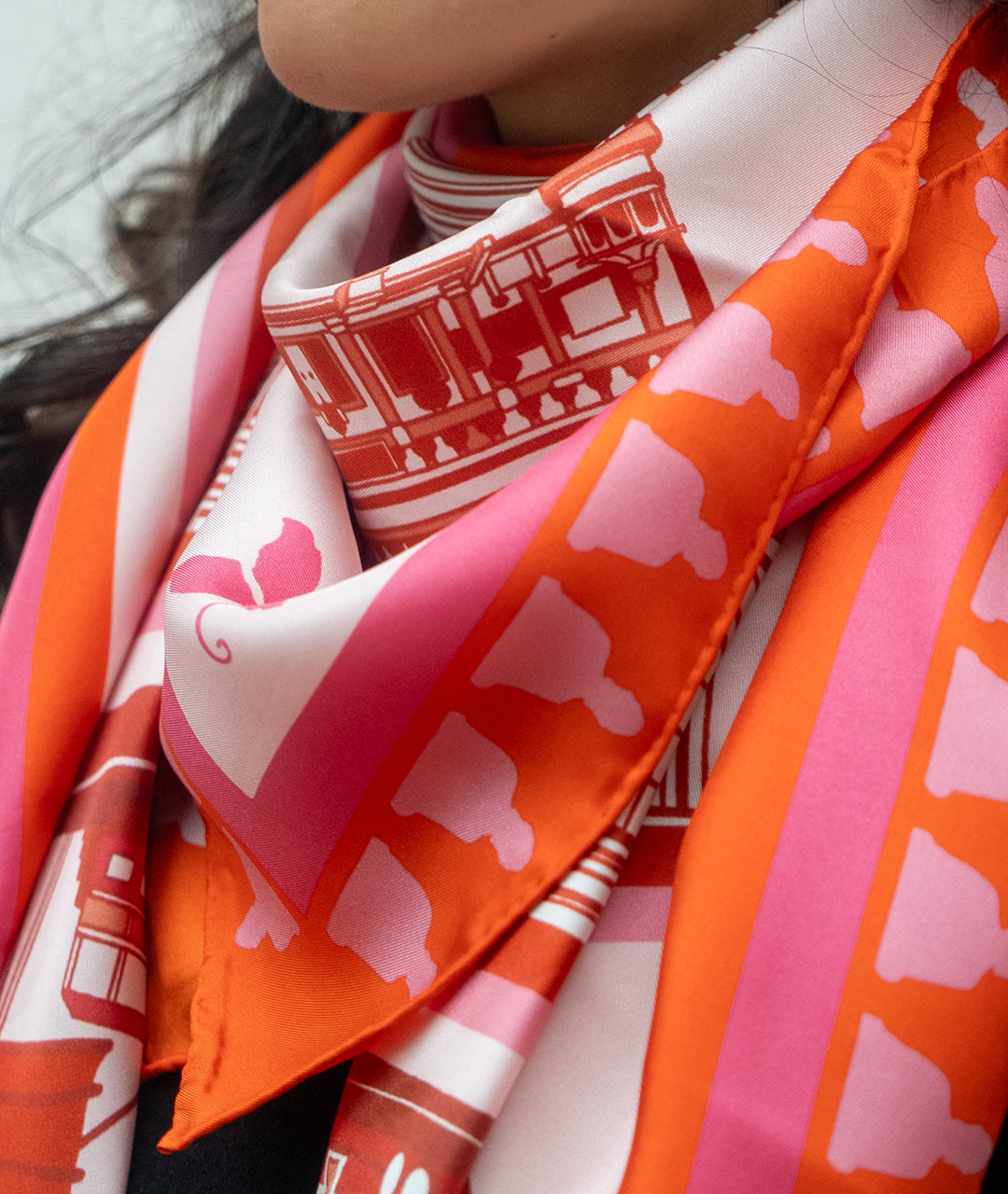Close-up of a colorful scarf with pink patterns.