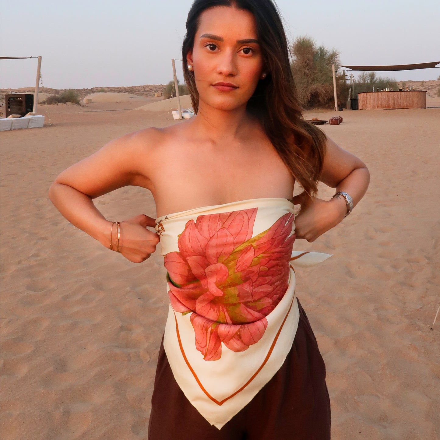 Woman wearing a botani bloom florimanie scarf as a top with a floral design in a desert setting