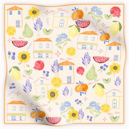 Decorative silk scarf with colorful houses, fruits, and flowers on a white background