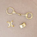 Gold scarf accessories on a beige background