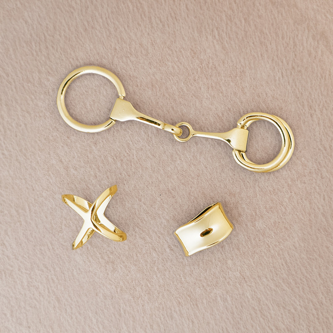 Gold scarf accessories on a beige background
