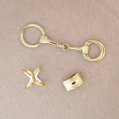 Gold scarf accessories on a beige background