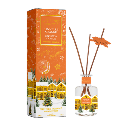 Botani Bloom cinnamon orange reed diffuser with packaging featuring a christmas snowy village design.