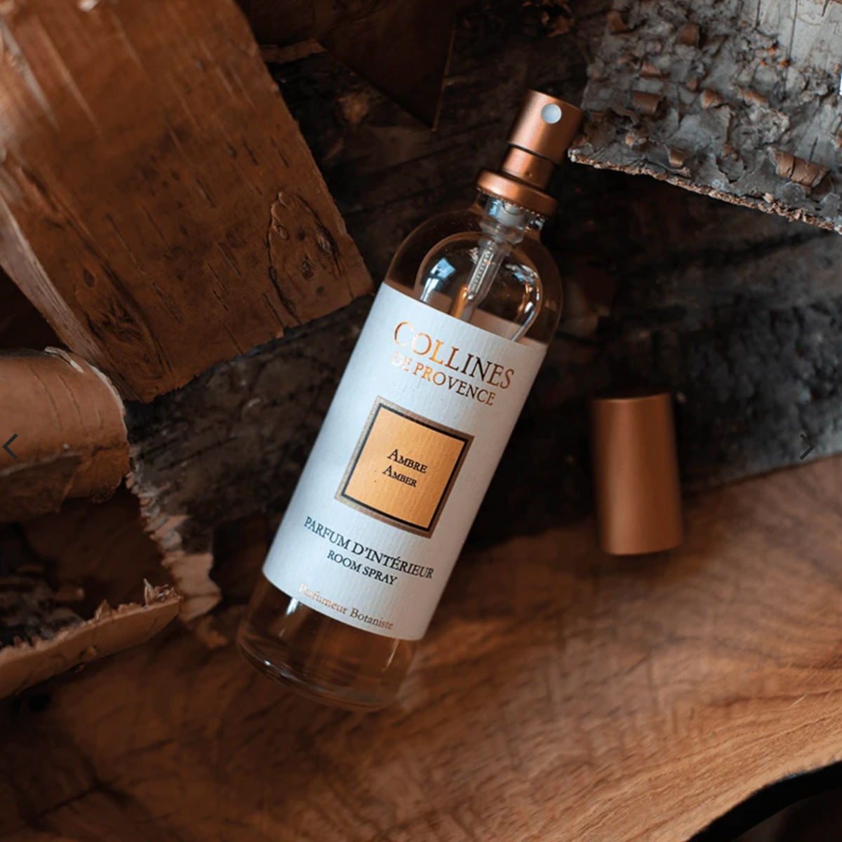 Amber Room Spray, on a wooden surface