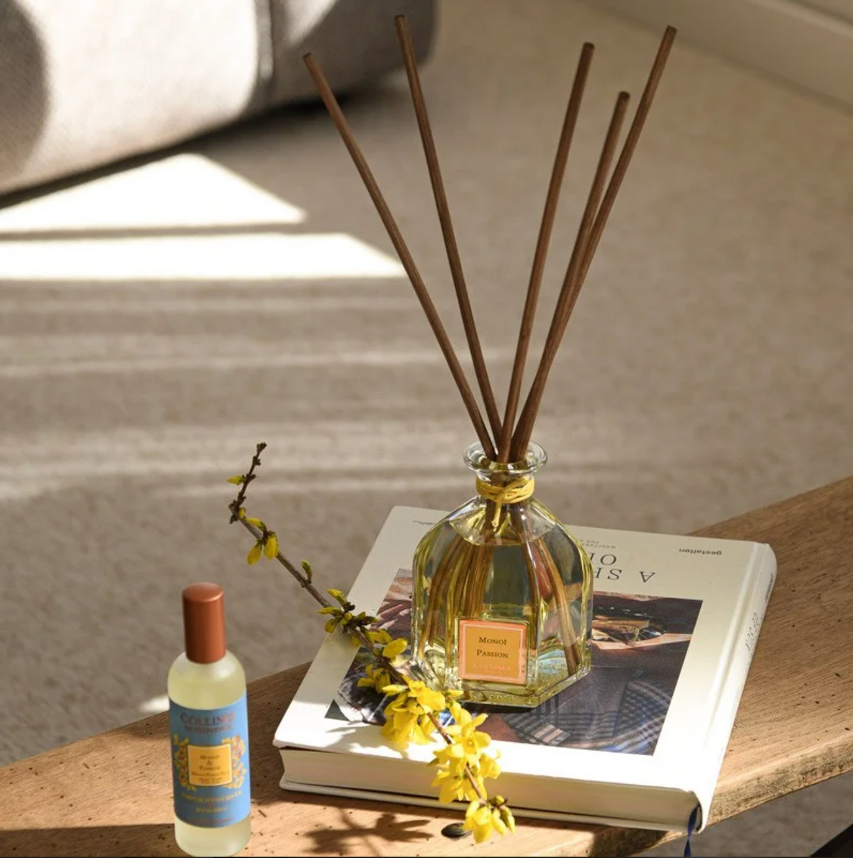 Monoi & Passion Fruit Reed Diffuser, in use, on book