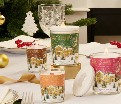 Collines de Provence christmas collection scented candles on a festive table with Christmas decorations.