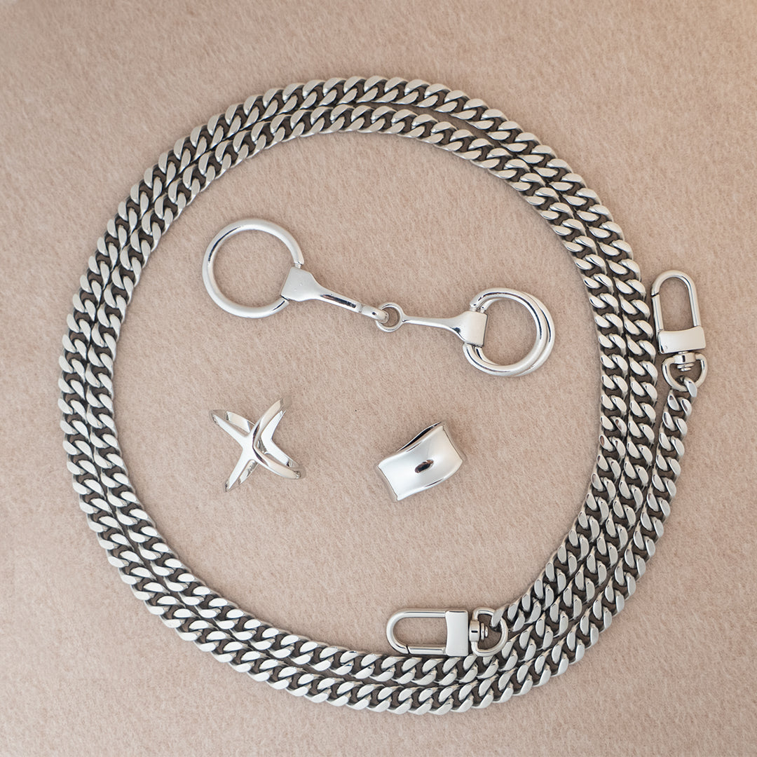 Botani Bloom silk scarf accessories including a silverchain with clasps on a beige background