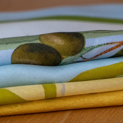 Stack of colorful scarves on a wooden surface