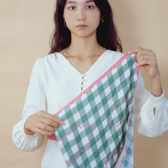 Video tutorial of a woman styling a botani bloom scarf