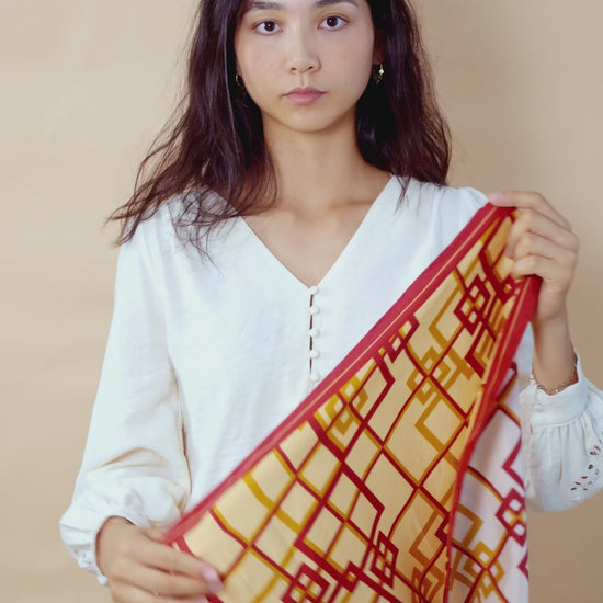 Video tutorial of a woman styling a labyrinth oriental scarf