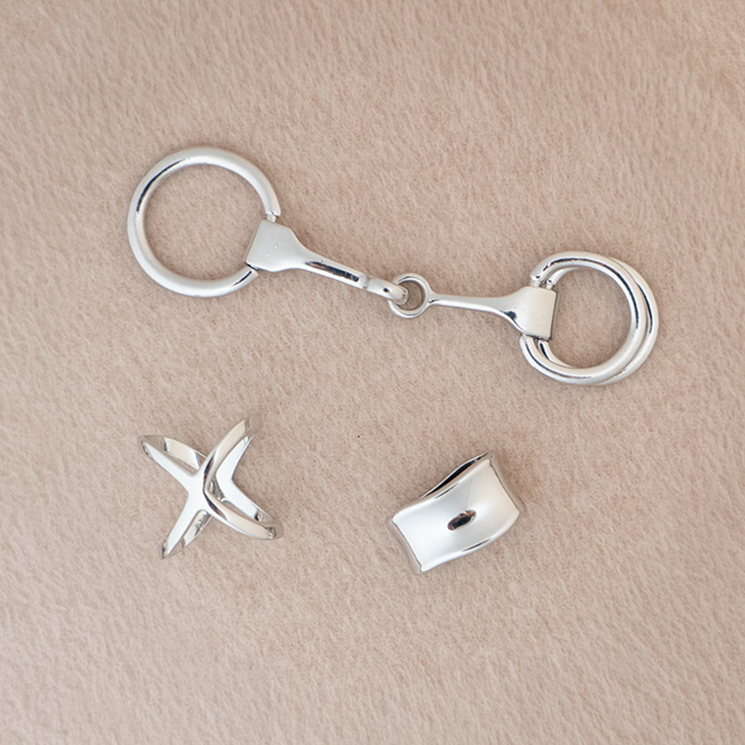 Silver scarf accessories on a beige background